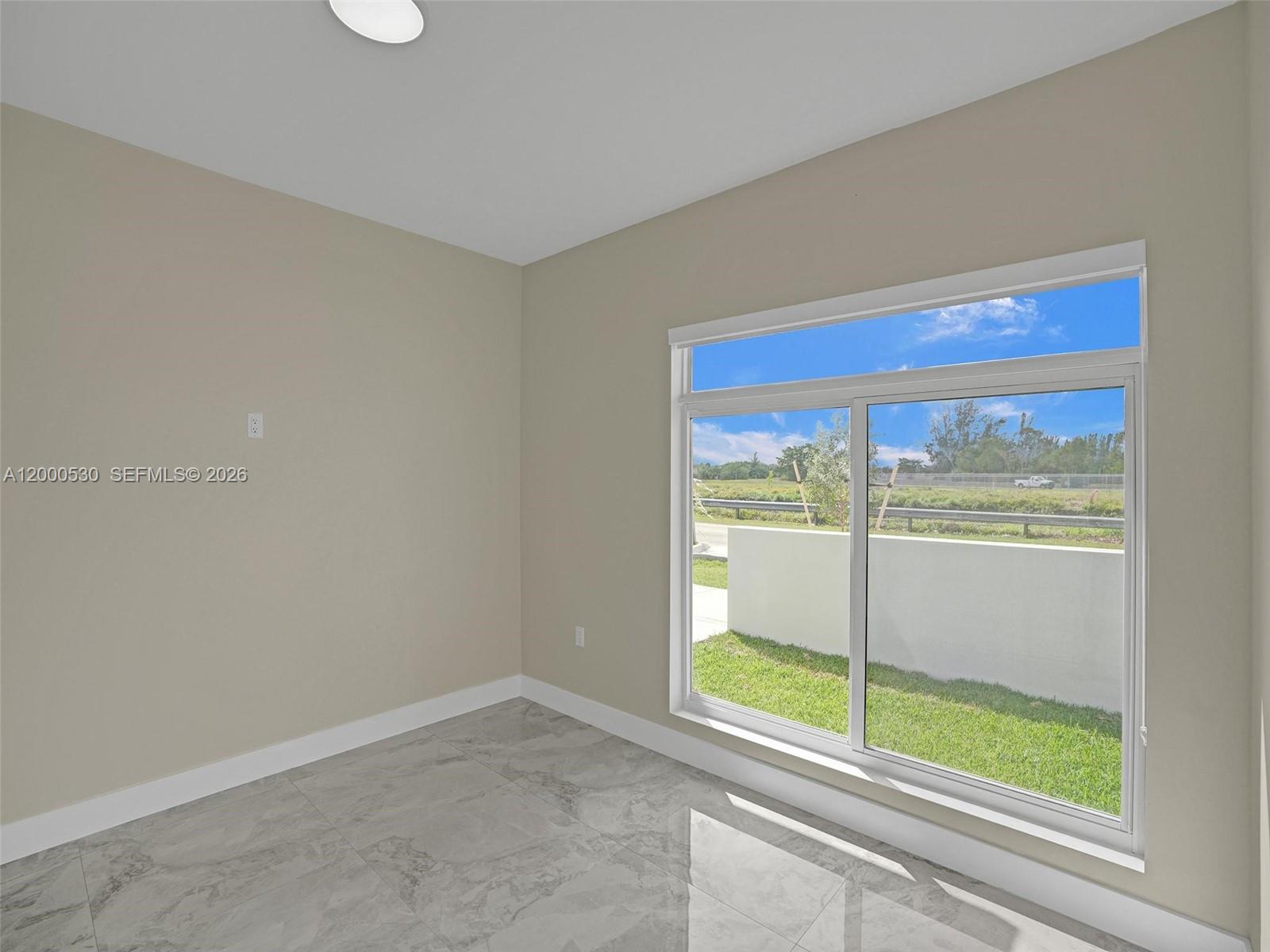 14519 Southwest 272nd Street, Unit 14519 Homestead, FL 33032 - Photo 14 of 32 a view of an empty room with a window