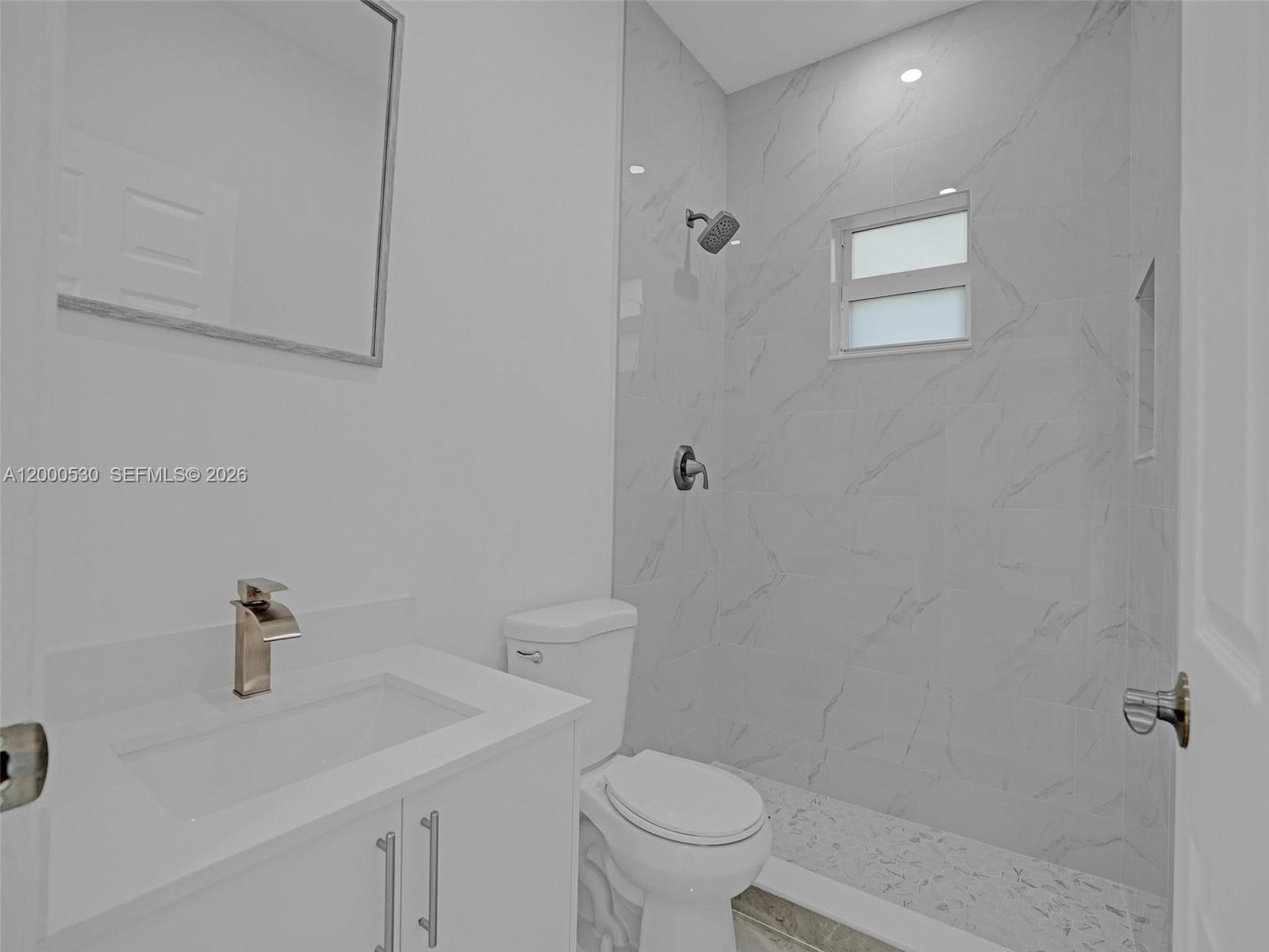 14519 Southwest 272nd Street, Unit 14519 Homestead, FL 33032 - Photo 15 of 32 a bathroom with a sink a toilet and shower