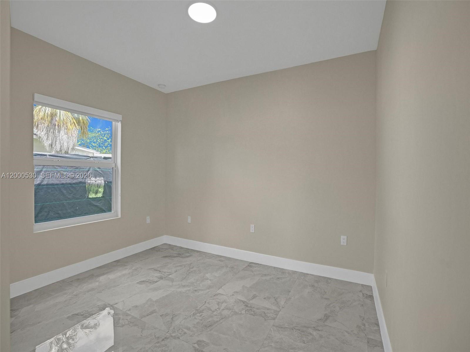 14519 Southwest 272nd Street, Unit 14519 Homestead, FL 33032 - Photo 17 of 32 an empty room with a window