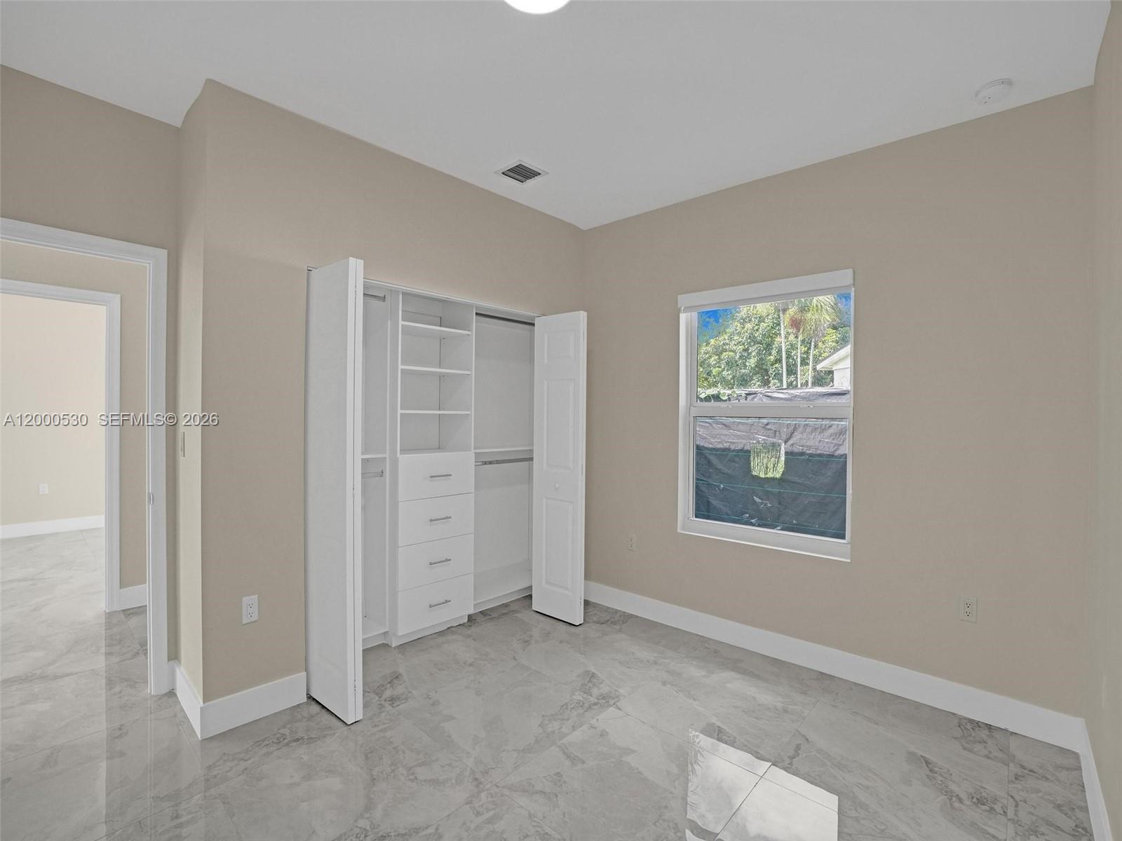14519 Southwest 272nd Street, Unit 14519 Homestead, FL 33032 - Photo 18 of 32 an empty room with windows