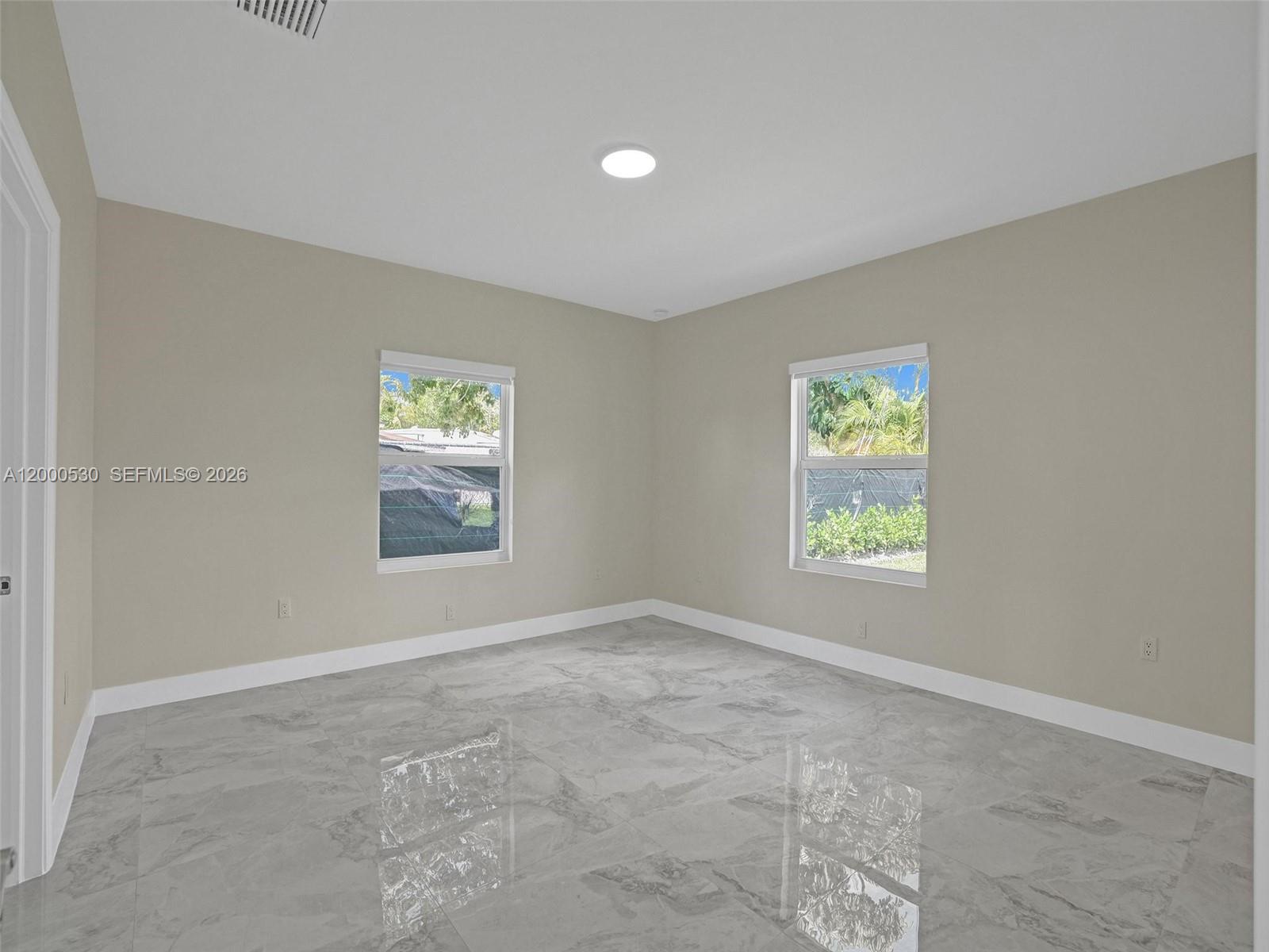 14519 Southwest 272nd Street, Unit 14519 Homestead, FL 33032 - Photo 20 of 32 an empty room with windows