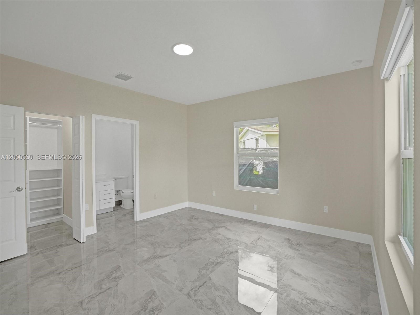 14519 Southwest 272nd Street, Unit 14519 Homestead, FL 33032 - Photo 21 of 32 an empty room with closet and windows