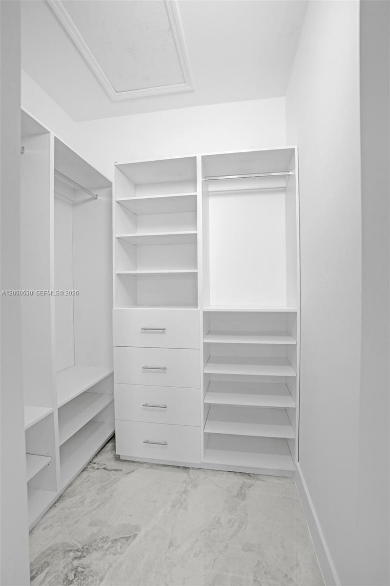 14519 Southwest 272nd Street, Unit 14519 Homestead, FL 33032 - Photo 22 of 32 a view of walk in closet with empty racks