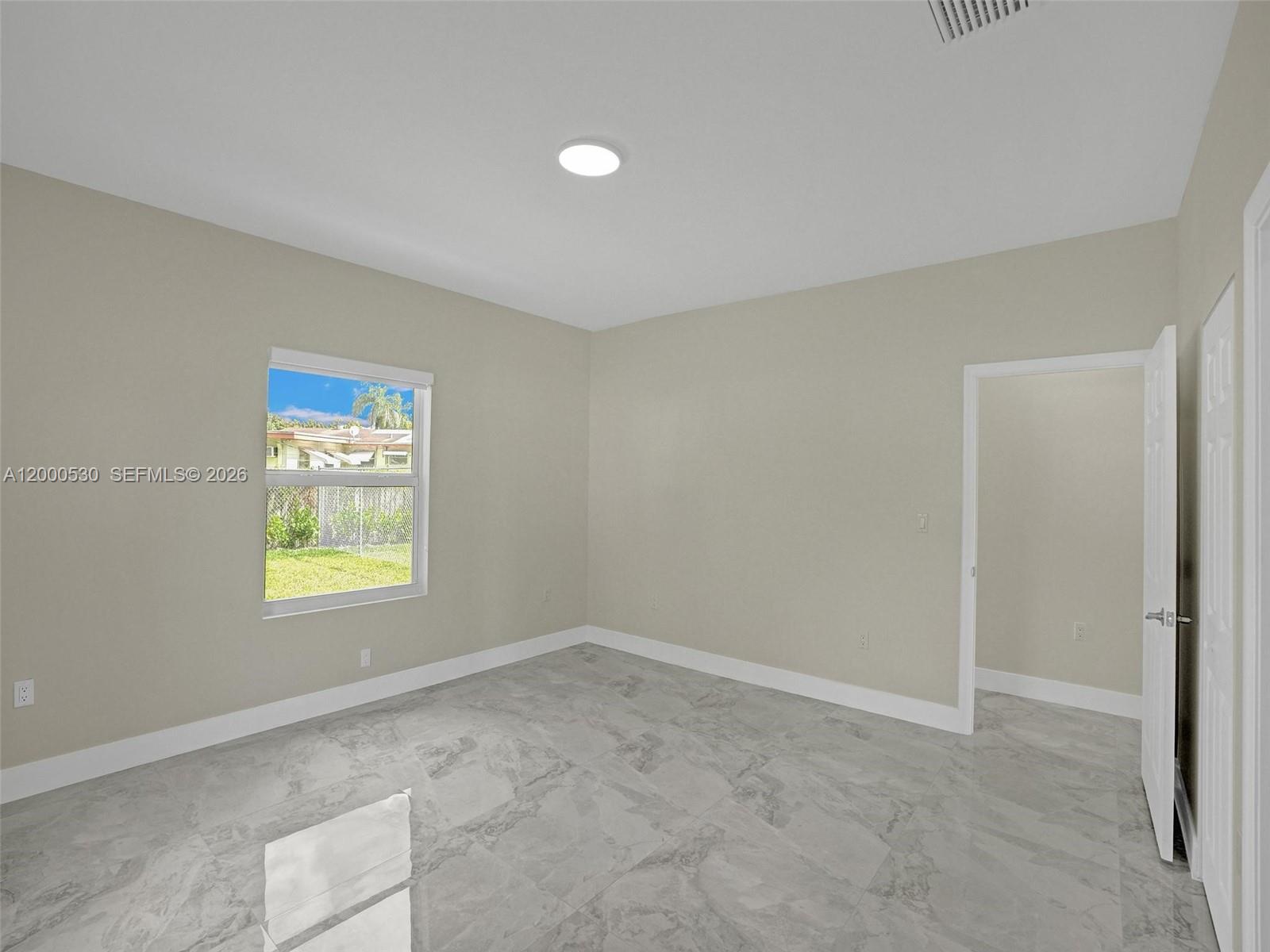 14519 Southwest 272nd Street, Unit 14519 Homestead, FL 33032 - Photo 24 of 32 a view of an empty room and window