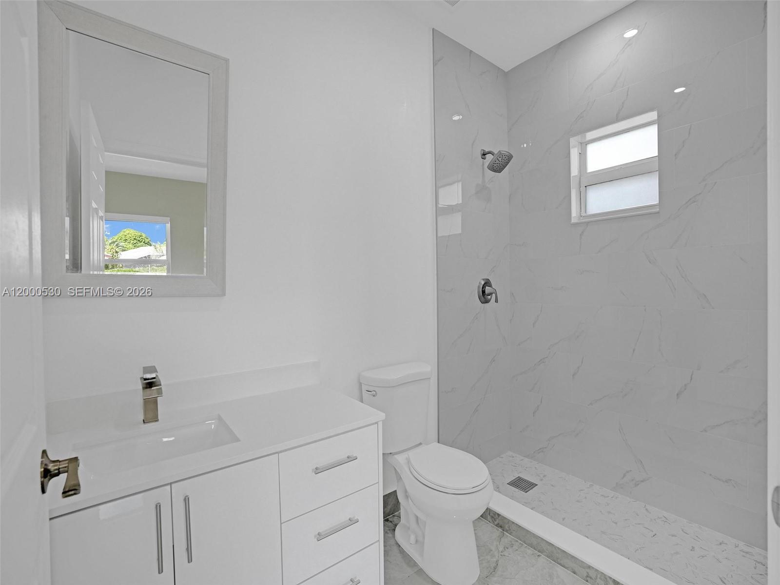 14519 Southwest 272nd Street, Unit 14519 Homestead, FL 33032 - Photo 25 of 32 a white toilet sitting next to a bathroom sink