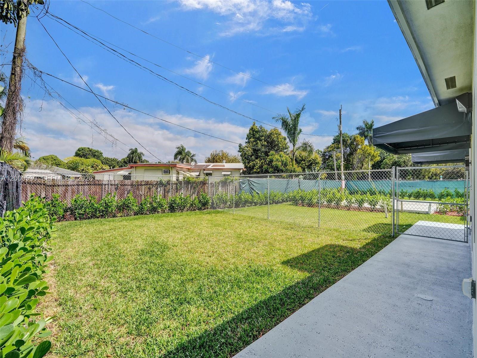 14519 Southwest 272nd Street, Unit 14519 Homestead, FL 33032 - Photo 27 of 32 a view of a back yard of the house