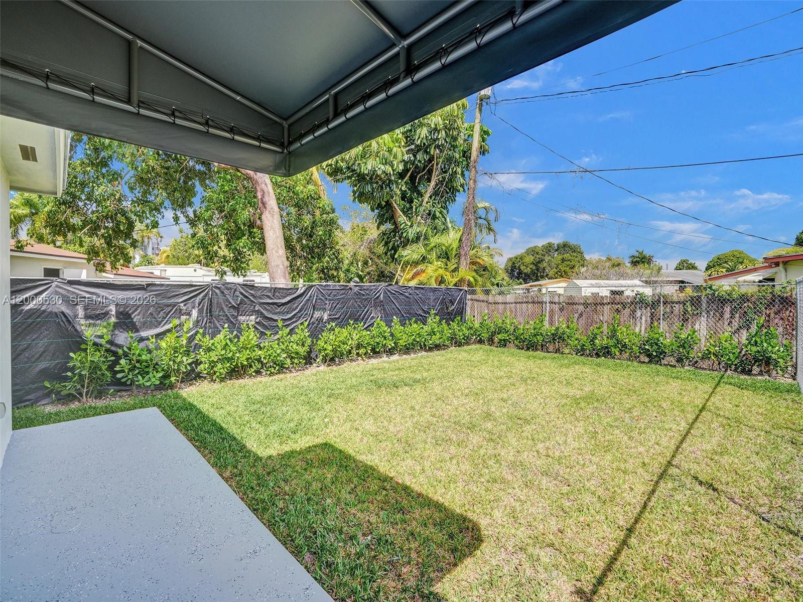14519 Southwest 272nd Street, Unit 14519 Homestead, FL 33032 - Photo 28 of 32 a view of a backyard with pathway