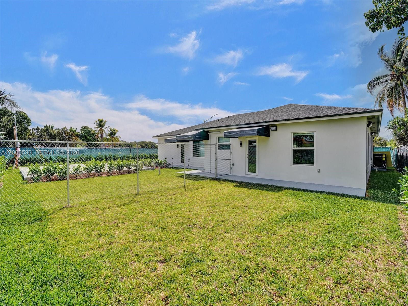 14519 Southwest 272nd Street, Unit 14519 Homestead, FL 33032 - Photo 29 of 32 a view of a house with a backyard