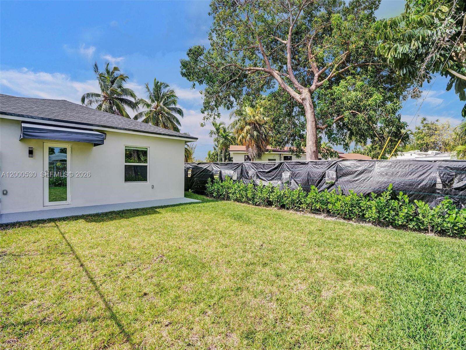 14519 Southwest 272nd Street, Unit 14519 Homestead, FL 33032 - Photo 30 of 32 a house view with a garden space