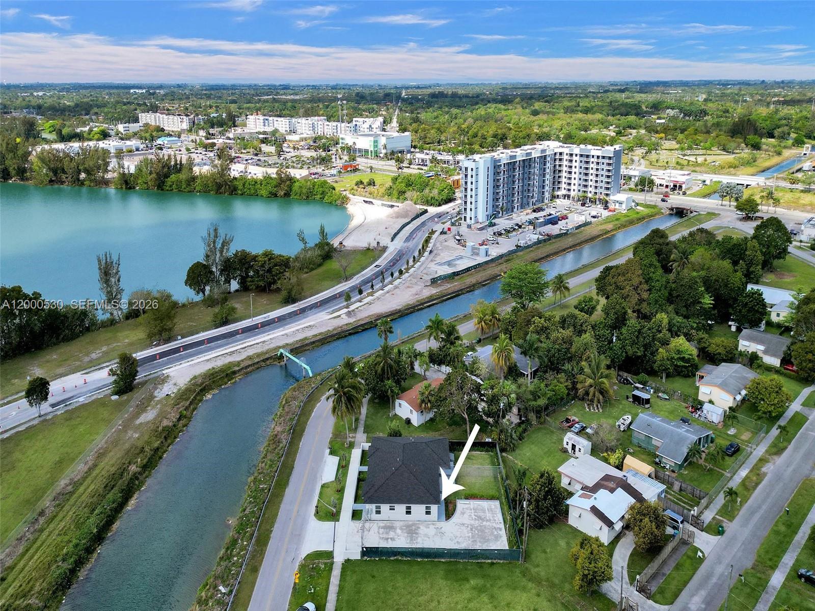 14519 Southwest 272nd Street, Unit 14519 Homestead, FL 33032 - Photo 32 of 32 an aerial view of a house with a garden and lake view