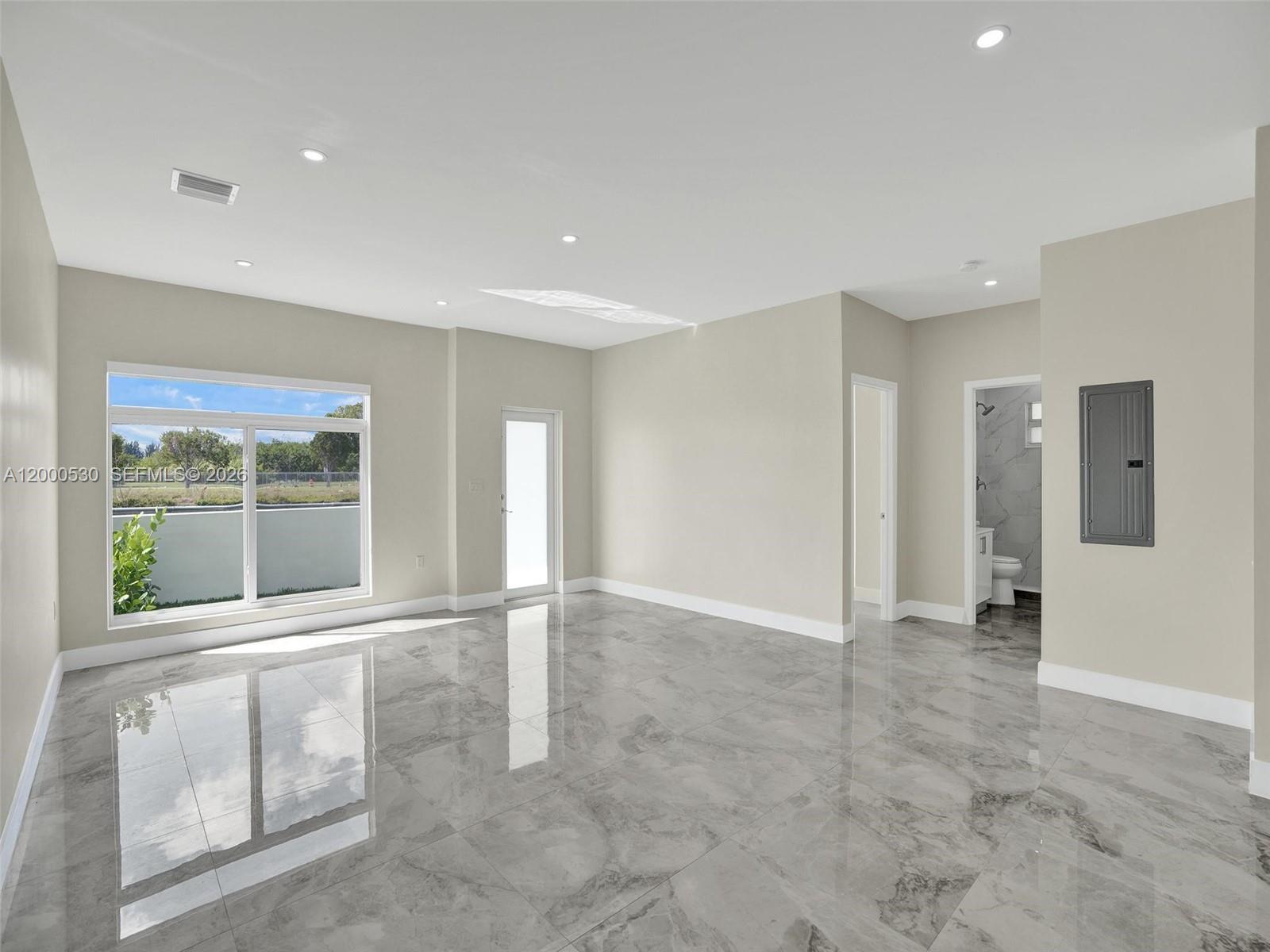 14519 Southwest 272nd Street, Unit 14519 Homestead, FL 33032 - Photo 4 of 32 a view of an empty room with a window