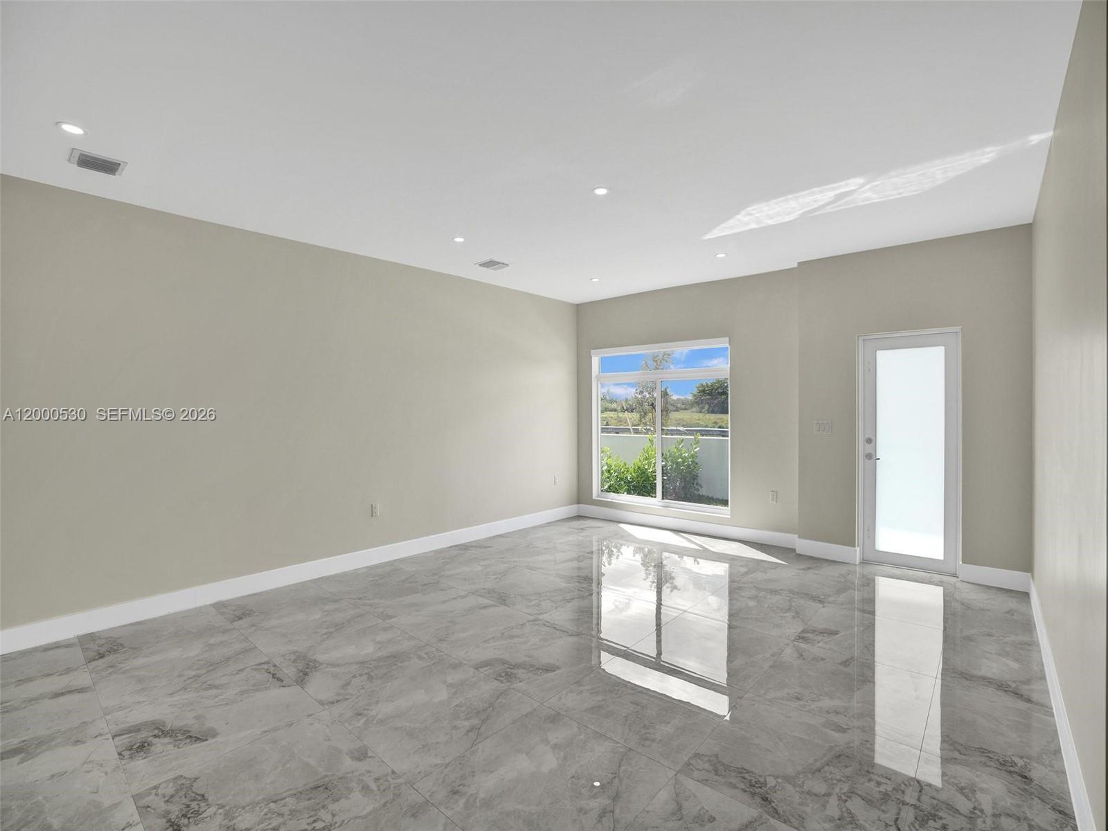 14519 Southwest 272nd Street, Unit 14519 Homestead, FL 33032 - Photo 5 of 32 a view of an empty room with a window