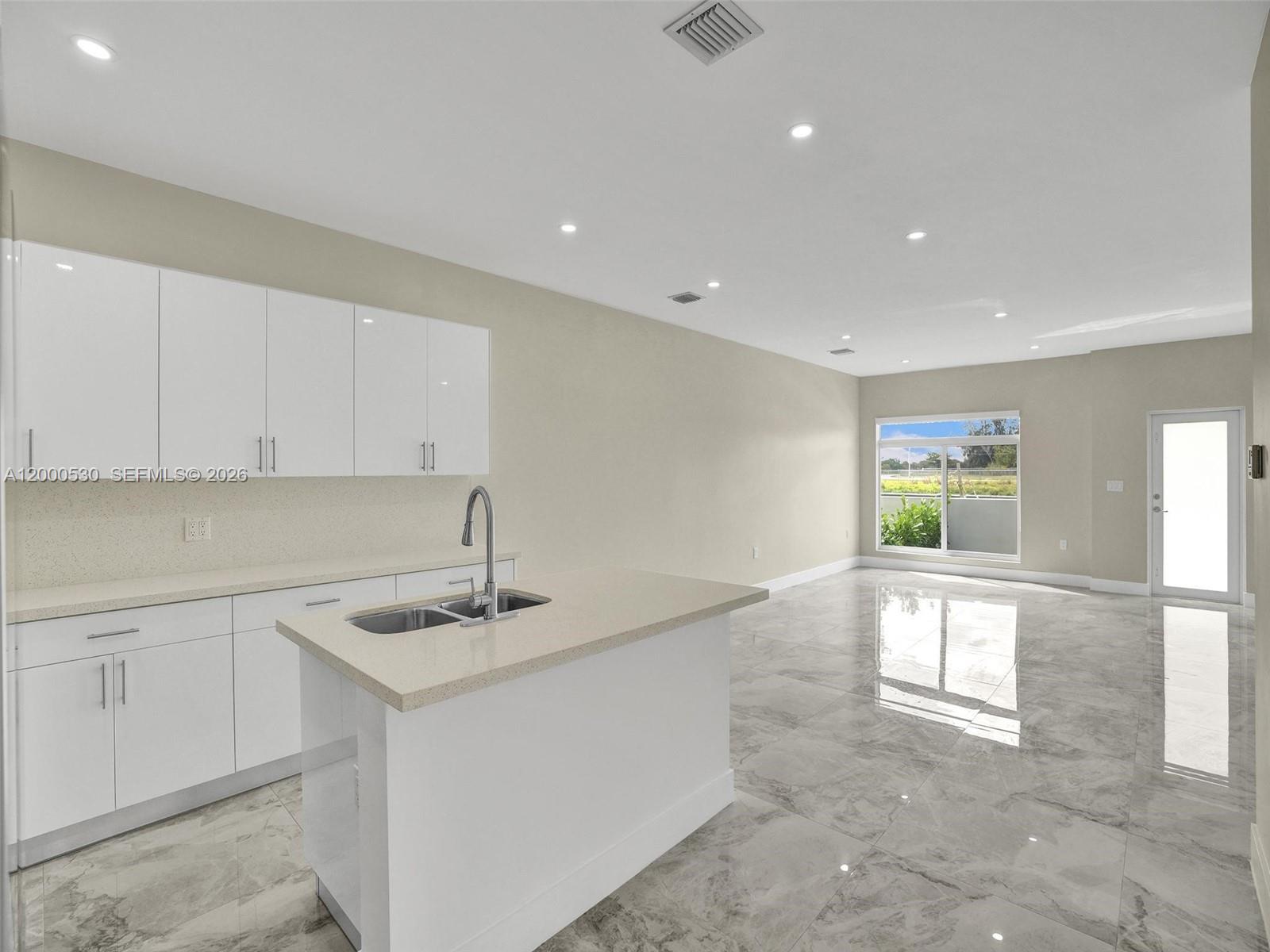 14519 Southwest 272nd Street, Unit 14519 Homestead, FL 33032 - Photo 8 of 32 a view of a kitchen with a sink and window