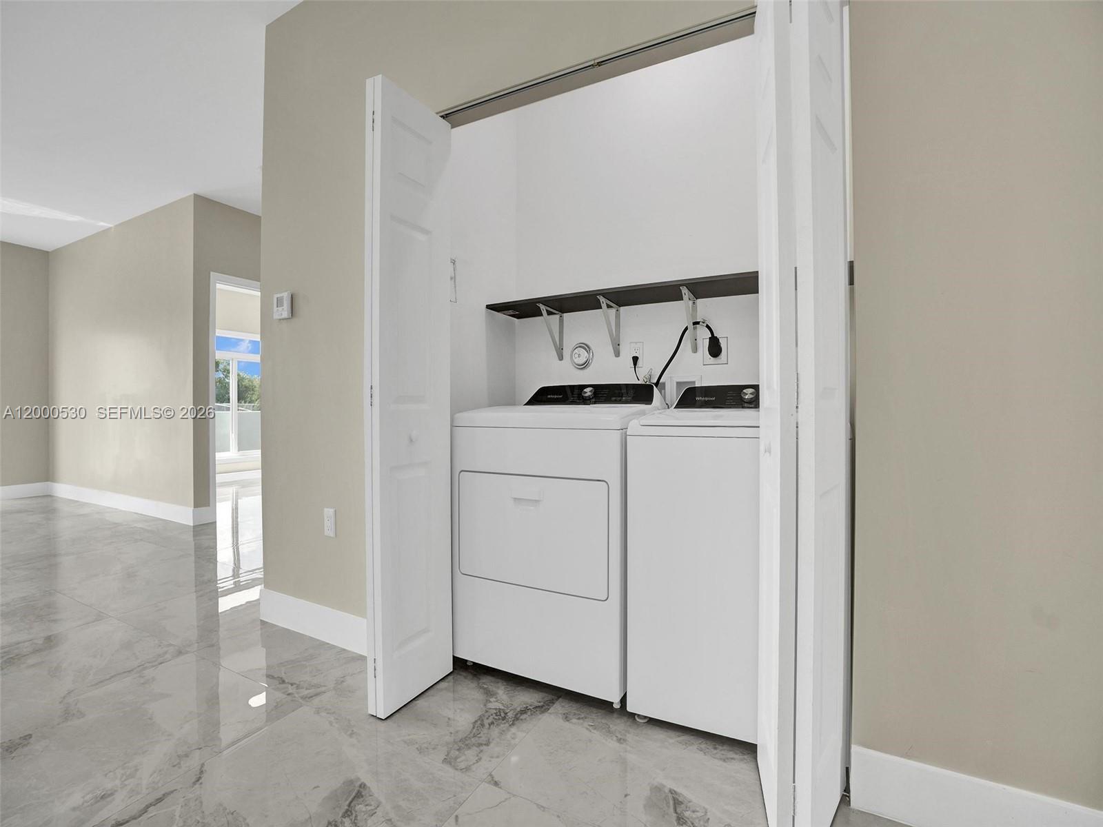 14519 Southwest 272nd Street, Unit 14519 Homestead, FL 33032 - Photo 10 of 32 a utility room with cabinets washer and dryer