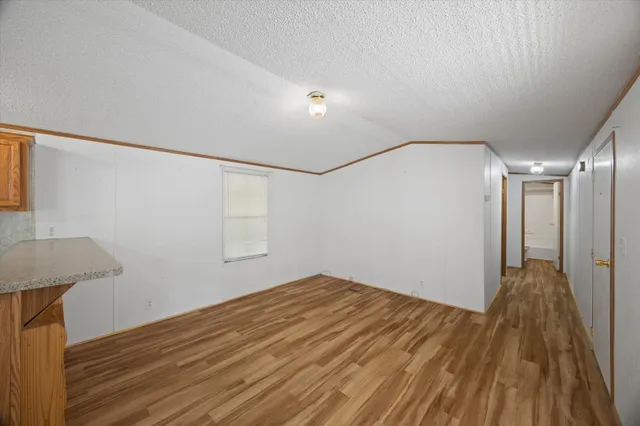 a view of hallway with wooden floor