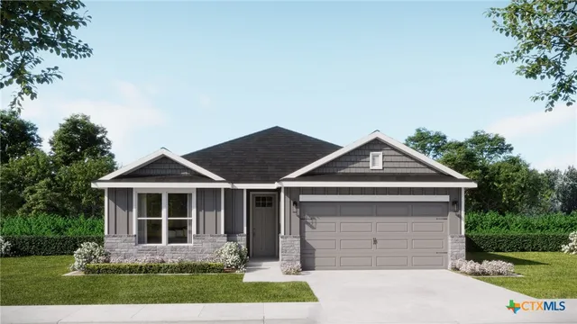 a front view of a house with a garden and plants