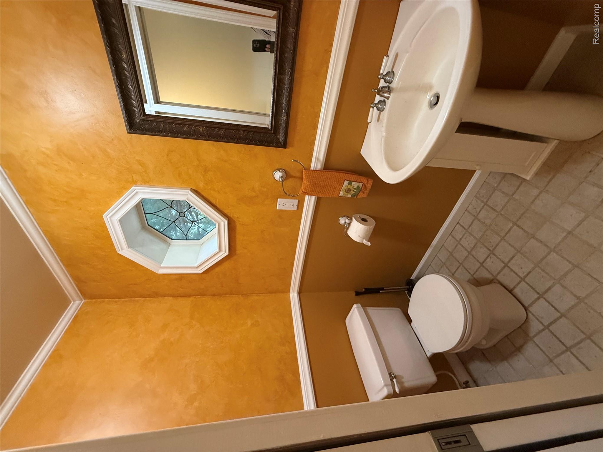 10280 Nimphie Road Fenton, MI 48430 - Photo 10 of 30 Pedestal sink with chrome fixtures, octagonal window, and crown molding