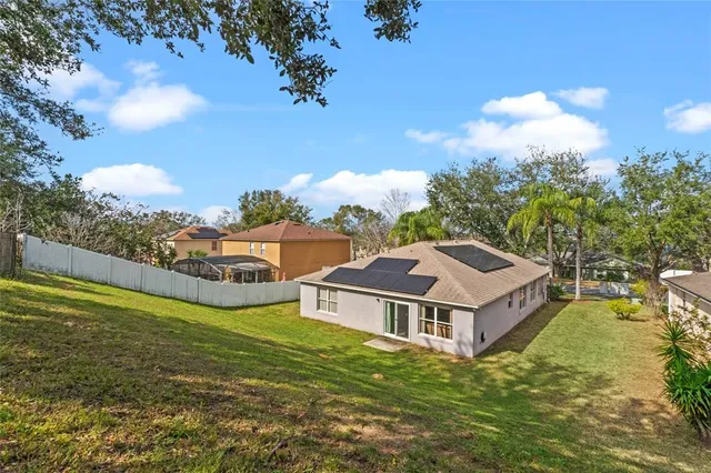 a view of a big room with a big yard and large trees