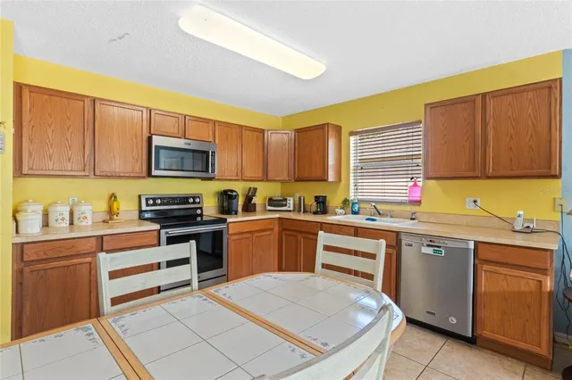 a kitchen with a sink stove top oven and microwave