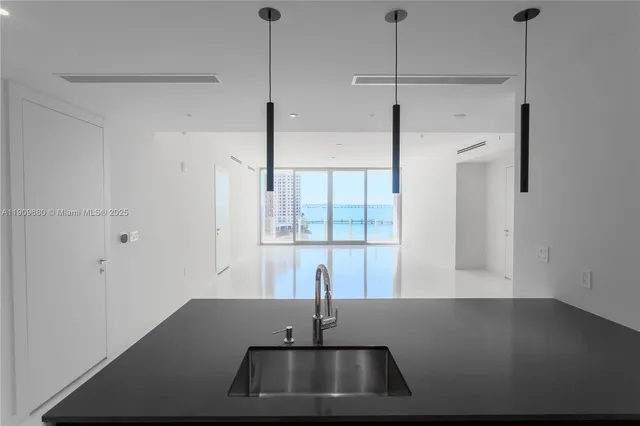 a view of a room with a sink wooden floor and windows