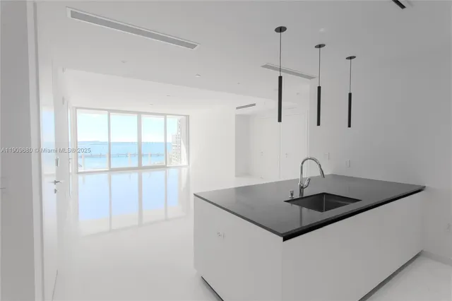 a kitchen with a sink a refrigerator and window