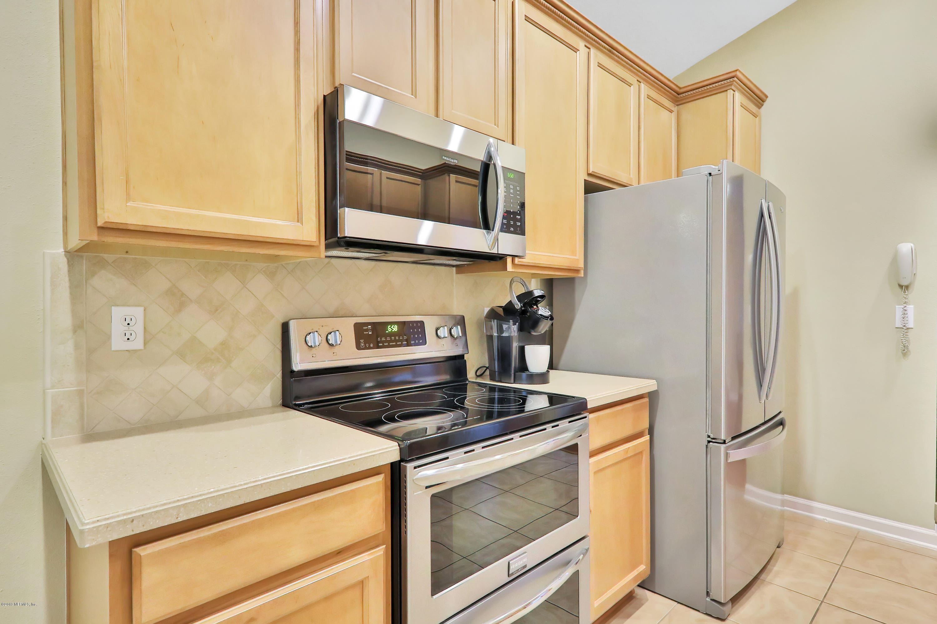3417 South Saxxon Road St. Augustine, FL 32092 - Photo 11 of 47 a kitchen with stainless steel appliances granite countertop a refrigerator and a stove