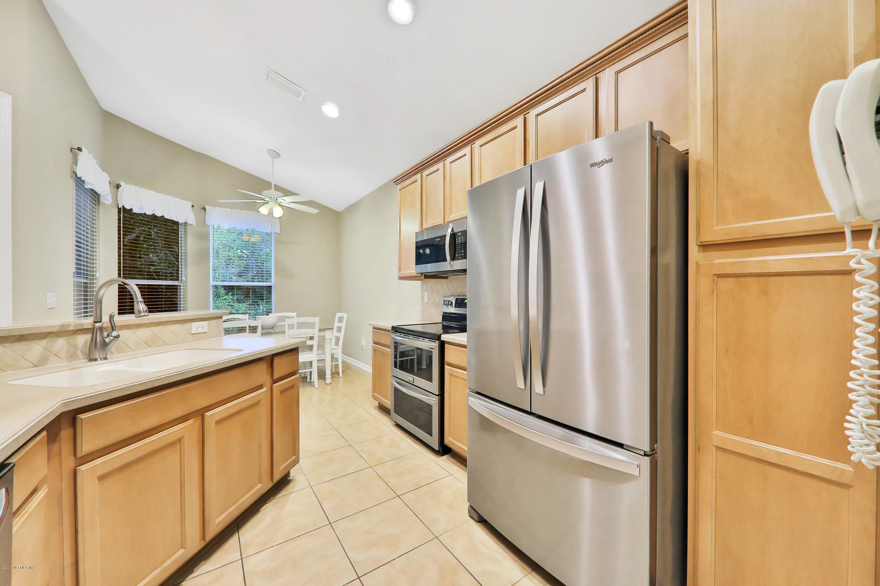 3417 South Saxxon Road St. Augustine, FL 32092 - Photo 13 of 47 a kitchen with stainless steel appliances granite countertop a refrigerator and a sink