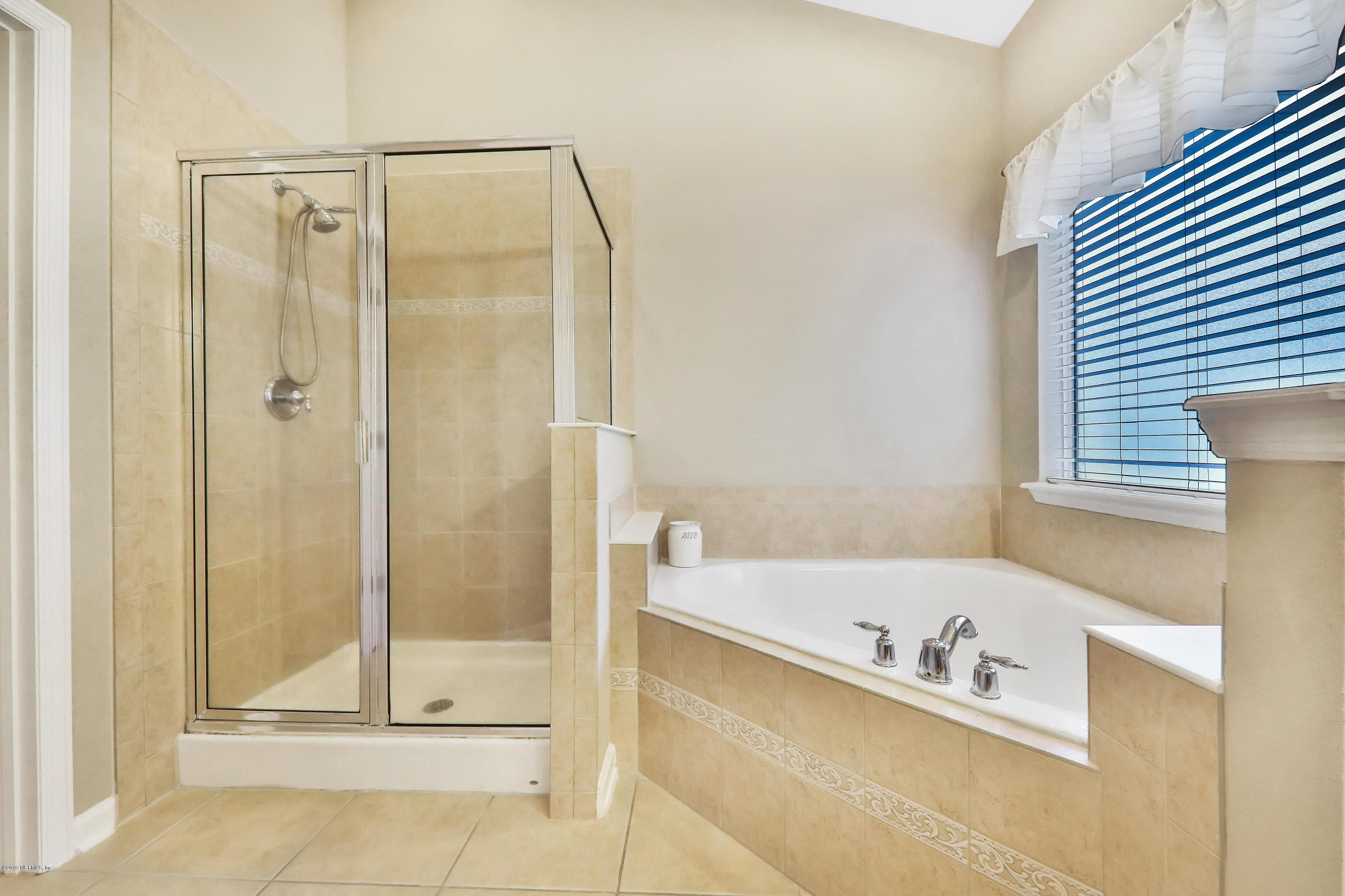 3417 South Saxxon Road St. Augustine, FL 32092 - Photo 20 of 47 a bathroom with a bathtub and a shower
