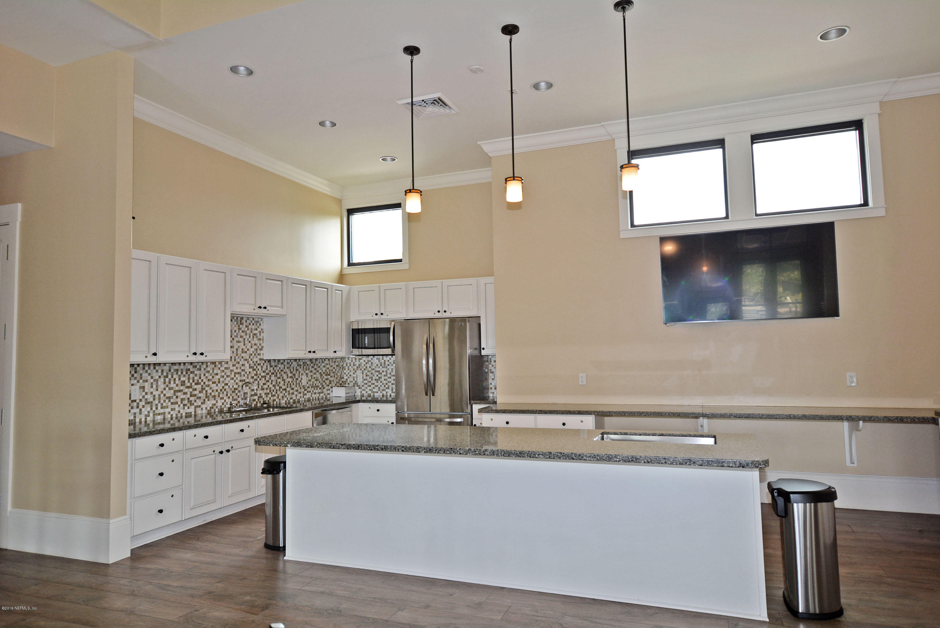 3417 South Saxxon Road St. Augustine, FL 32092 - Photo 38 of 47 a kitchen with kitchen island a counter top a stove a sink and a window