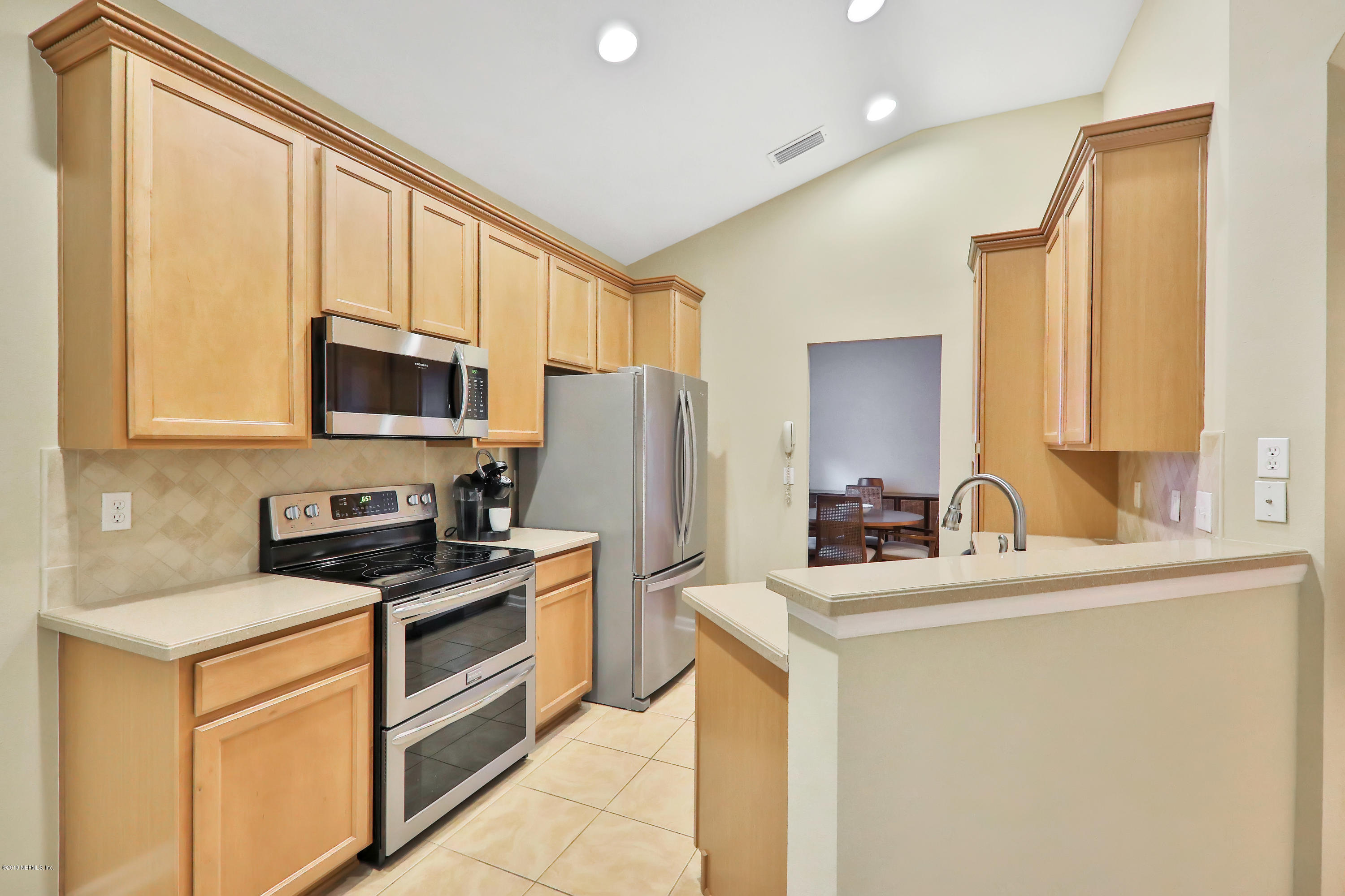 3417 South Saxxon Road St. Augustine, FL 32092 - Photo 10 of 47 a kitchen with stainless steel appliances granite countertop a sink stove refrigerator and cabinets
