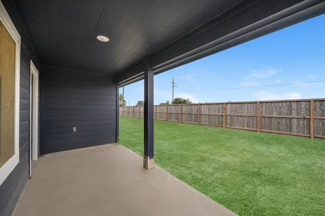 a view of a backyard with grass