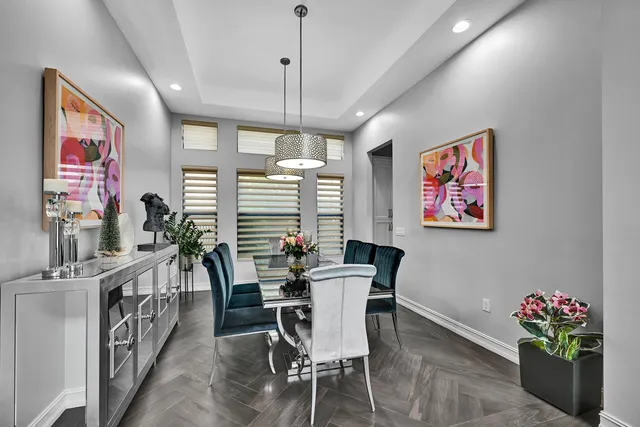 a view of dinning room and livingroom with furniture wooden floor chandelier