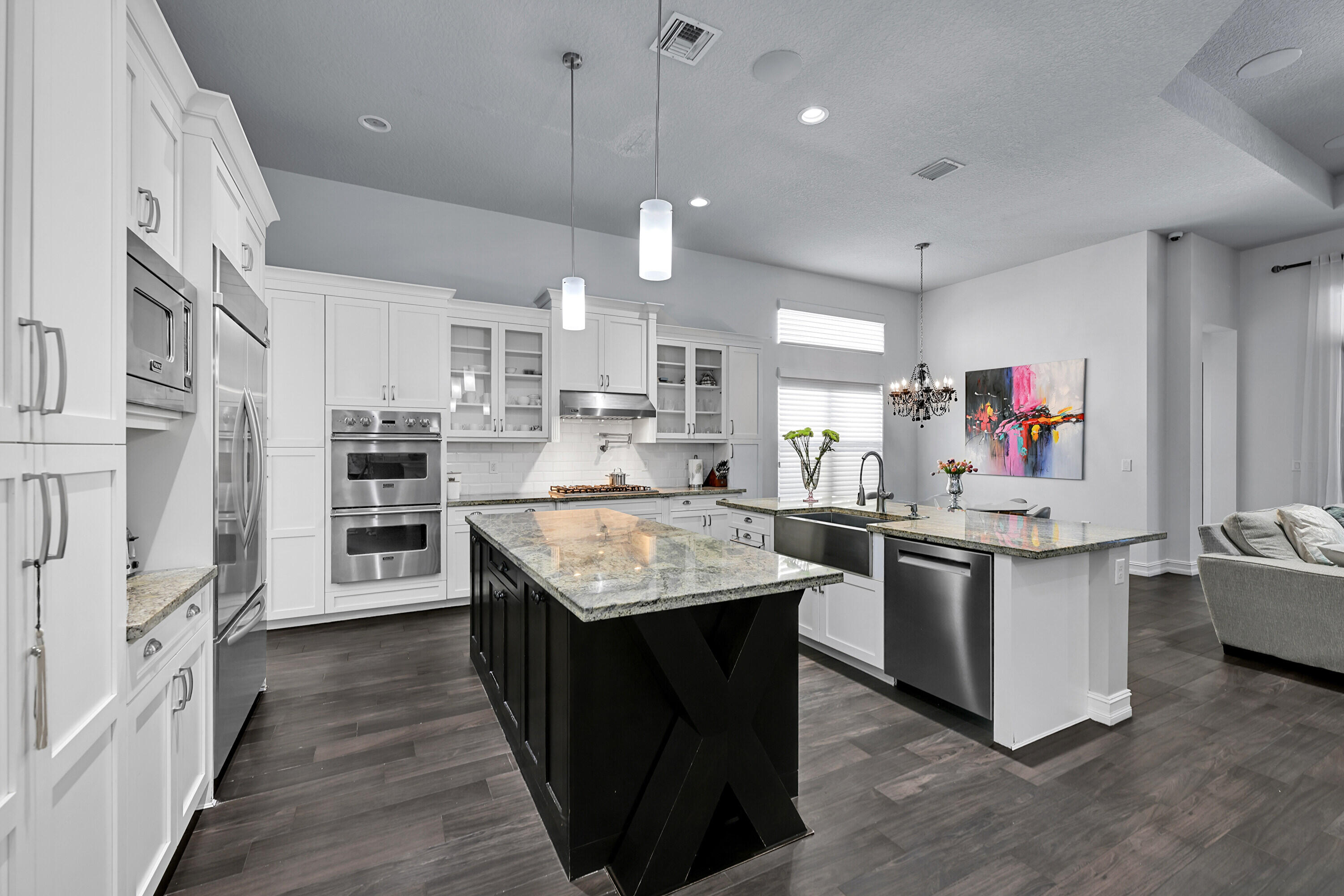 8652 Lewis River Road Delray Beach, FL 33446 - Photo 21 of 85 a kitchen with stainless steel appliances granite countertop a sink stove and wooden floor