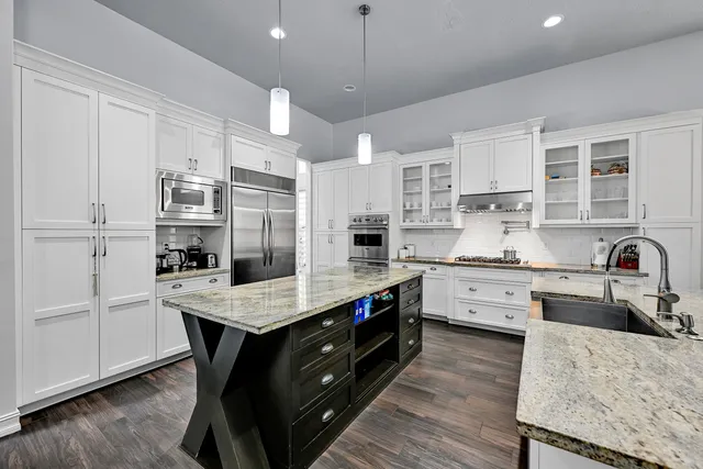 a kitchen with granite countertop stainless steel appliances and wooden cabinets