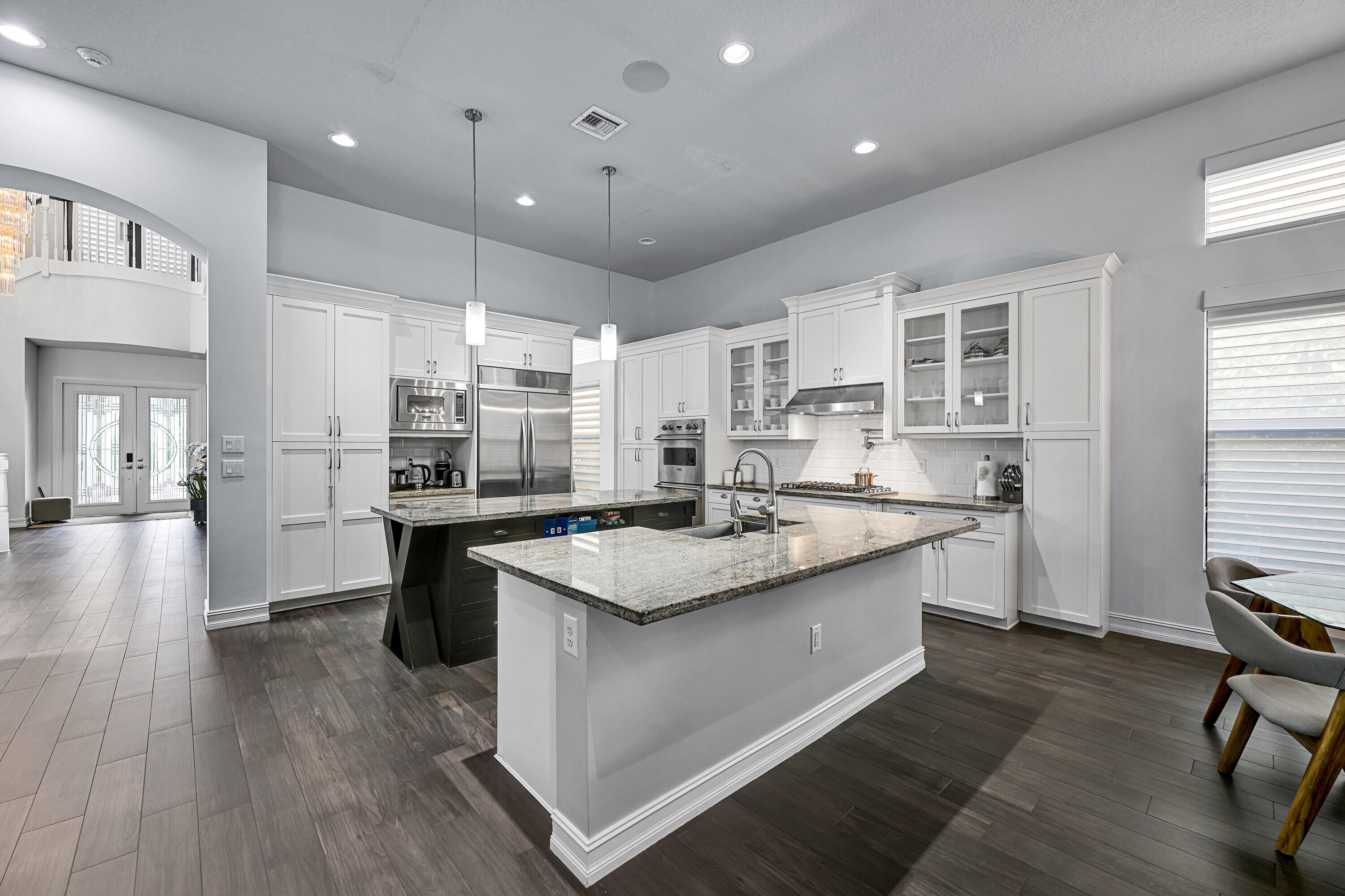 8652 Lewis River Road Delray Beach, FL 33446 - Photo 25 of 85 a kitchen with stainless steel appliances granite countertop a sink stove and wooden floor