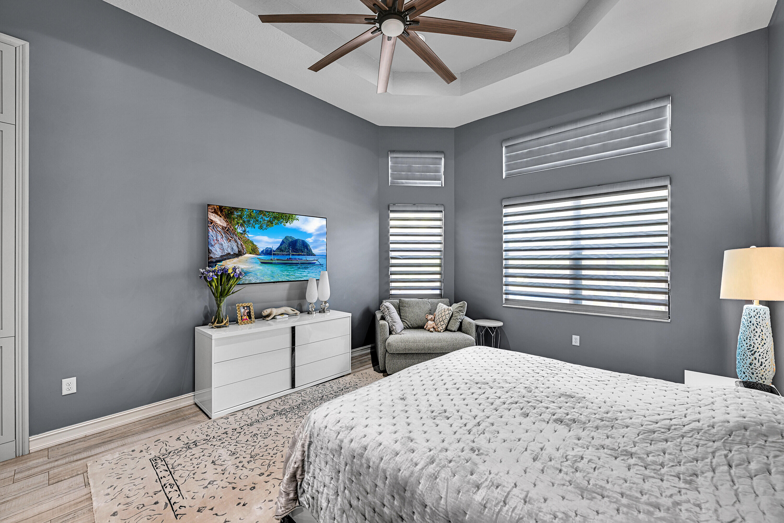 8652 Lewis River Road Delray Beach, FL 33446 - Photo 45 of 85 a bedroom with a bed and a chandelier