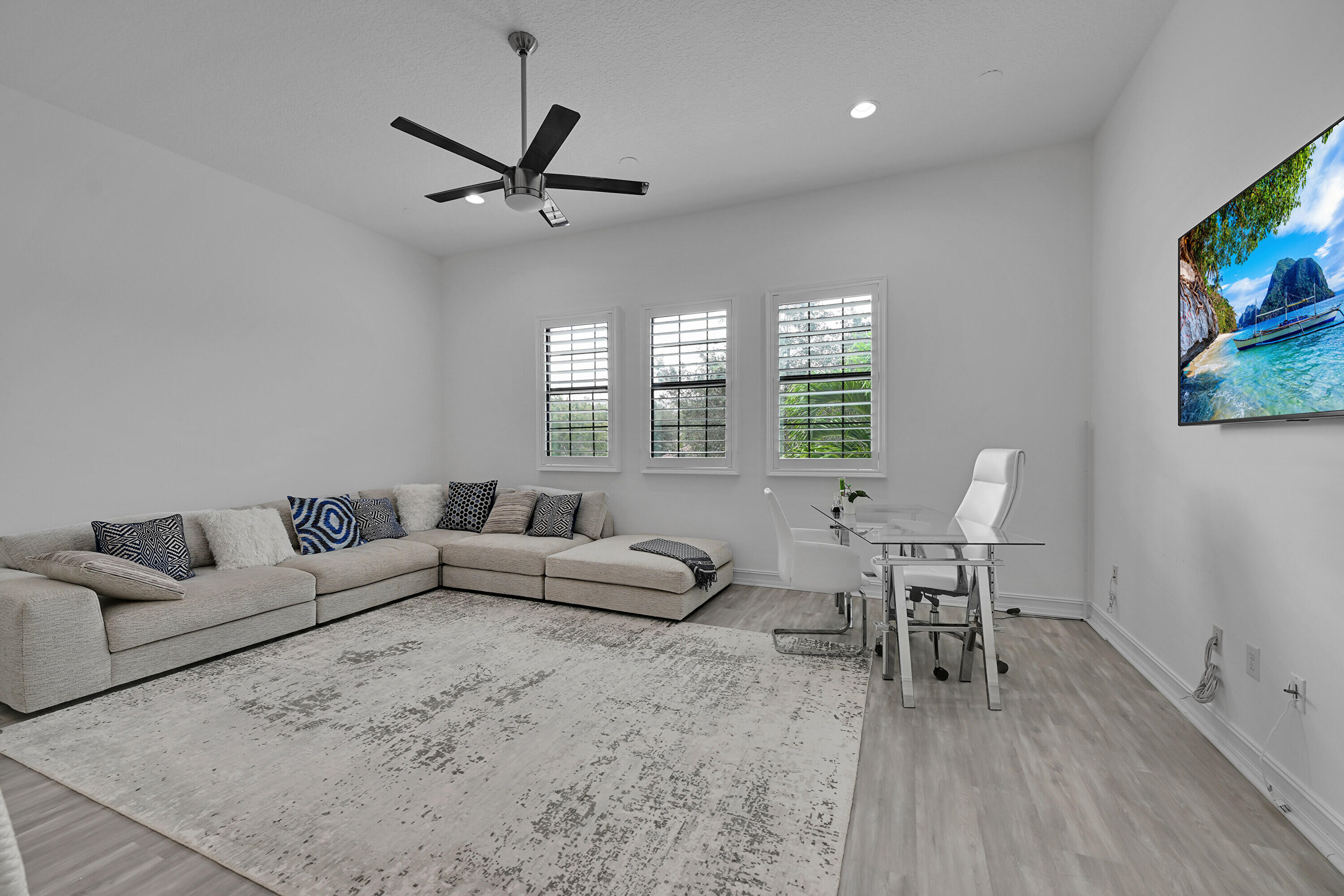 8652 Lewis River Road Delray Beach, FL 33446 - Photo 56 of 85 a living room with furniture and a flat screen tv