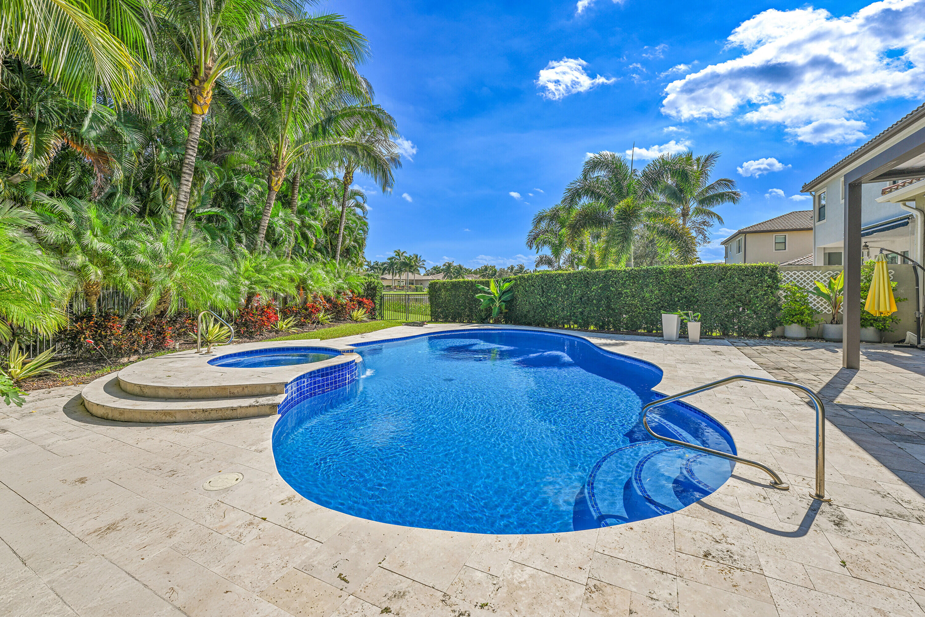 8652 Lewis River Road Delray Beach, FL 33446 - Photo 65 of 85 a view of a swimming pool with an outdoor space and seating area