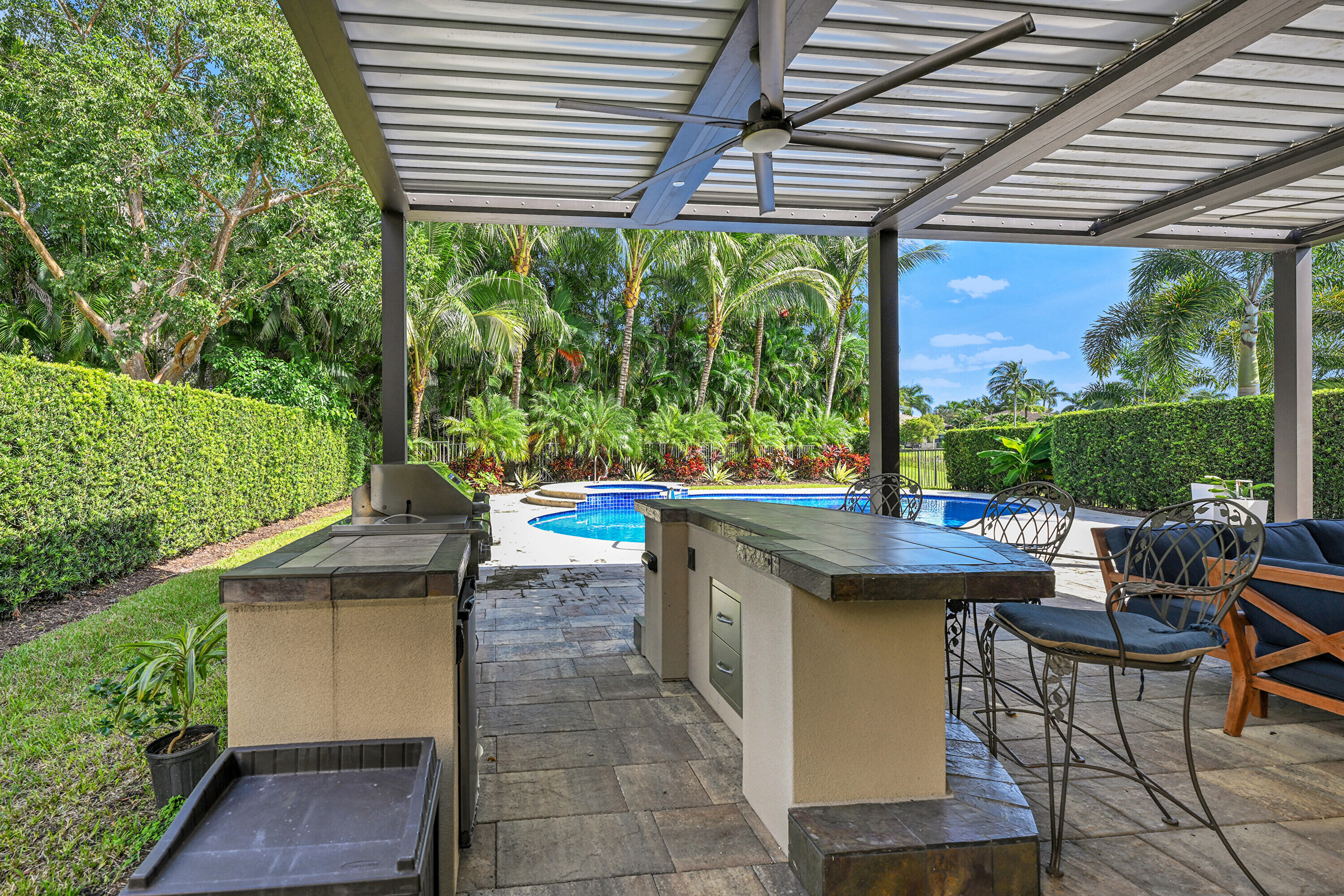 8652 Lewis River Road Delray Beach, FL 33446 - Photo 81 of 85 a view of a patio with table and chairs potted plants with wooden floor and fence
