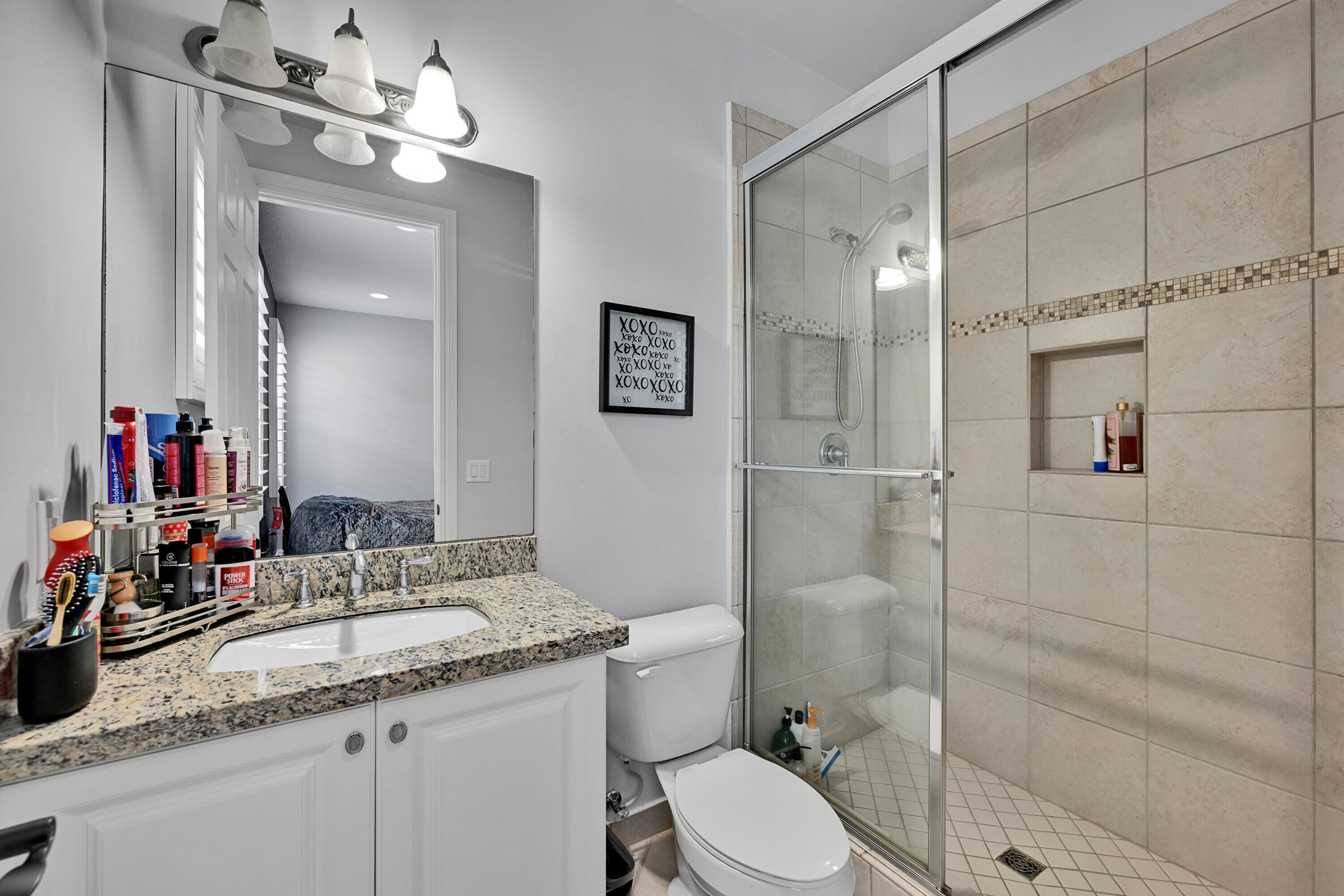8652 Lewis River Road Delray Beach, FL 33446 - Photo 82 of 85 a bathroom with a granite countertop sink toilet a mirror and shower
