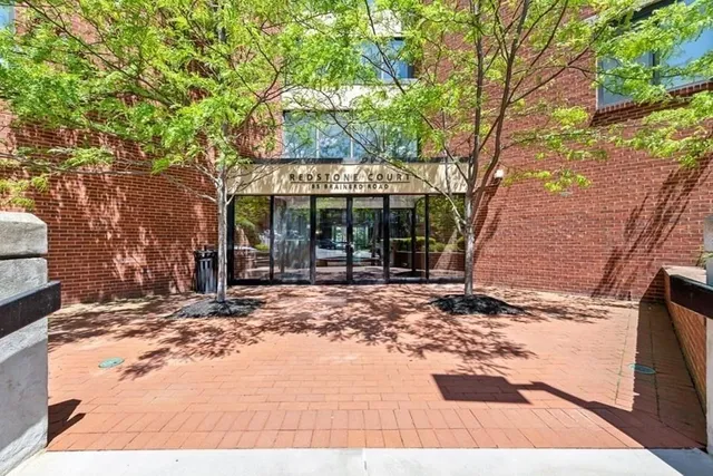 a view of a house with a tree in the background