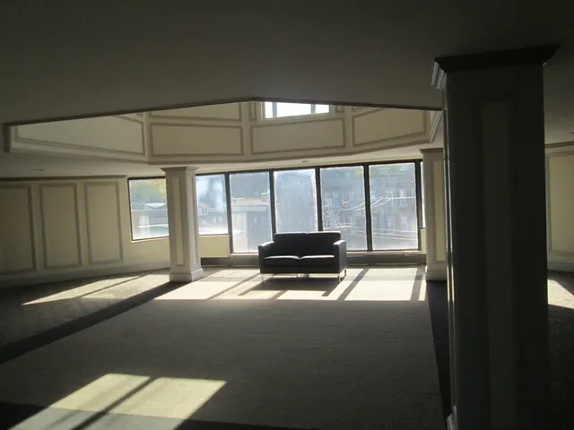 a view of a room with furniture and floor to ceiling window