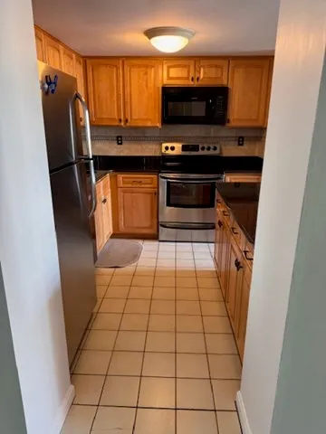 a kitchen with stainless steel appliances a stove a sink and a refrigerator