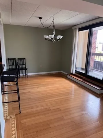 a view of room with window and wooden floor