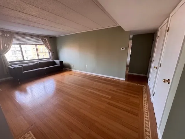 wooden floor in an empty room with a window