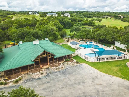an aerial view of a house with a garden and lake view