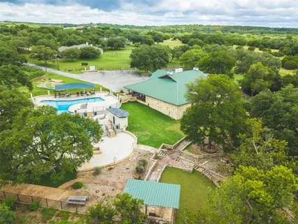 an aerial view of residential houses with outdoor space and street view