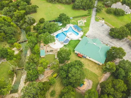 an aerial view of a houses with swimming pool
