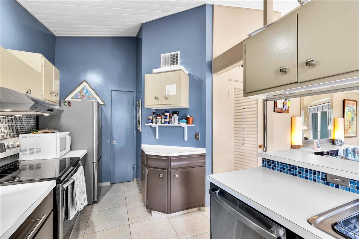 37800 Da Vall Drive, Unit 1 Rancho Mirage, CA 92270 - Photo 15 of 36 a kitchen with a sink stove and cabinets