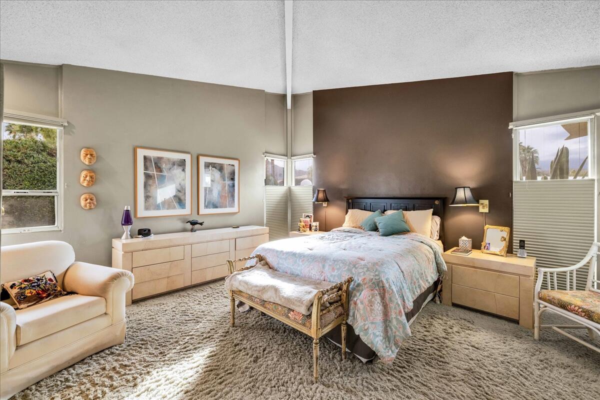 37800 Da Vall Drive, Unit 1 Rancho Mirage, CA 92270 - Photo 16 of 36 a spacious bedroom with a bed and a couch